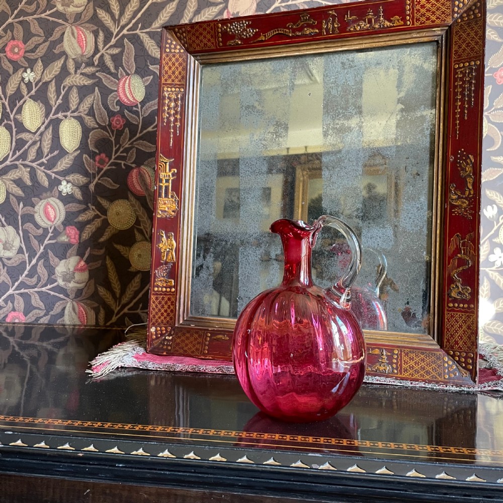 A rectangular red lacquered and Japanned wooden mirror featuring hand-painted gold oriental motifs and aged glass with silver foxing. View II