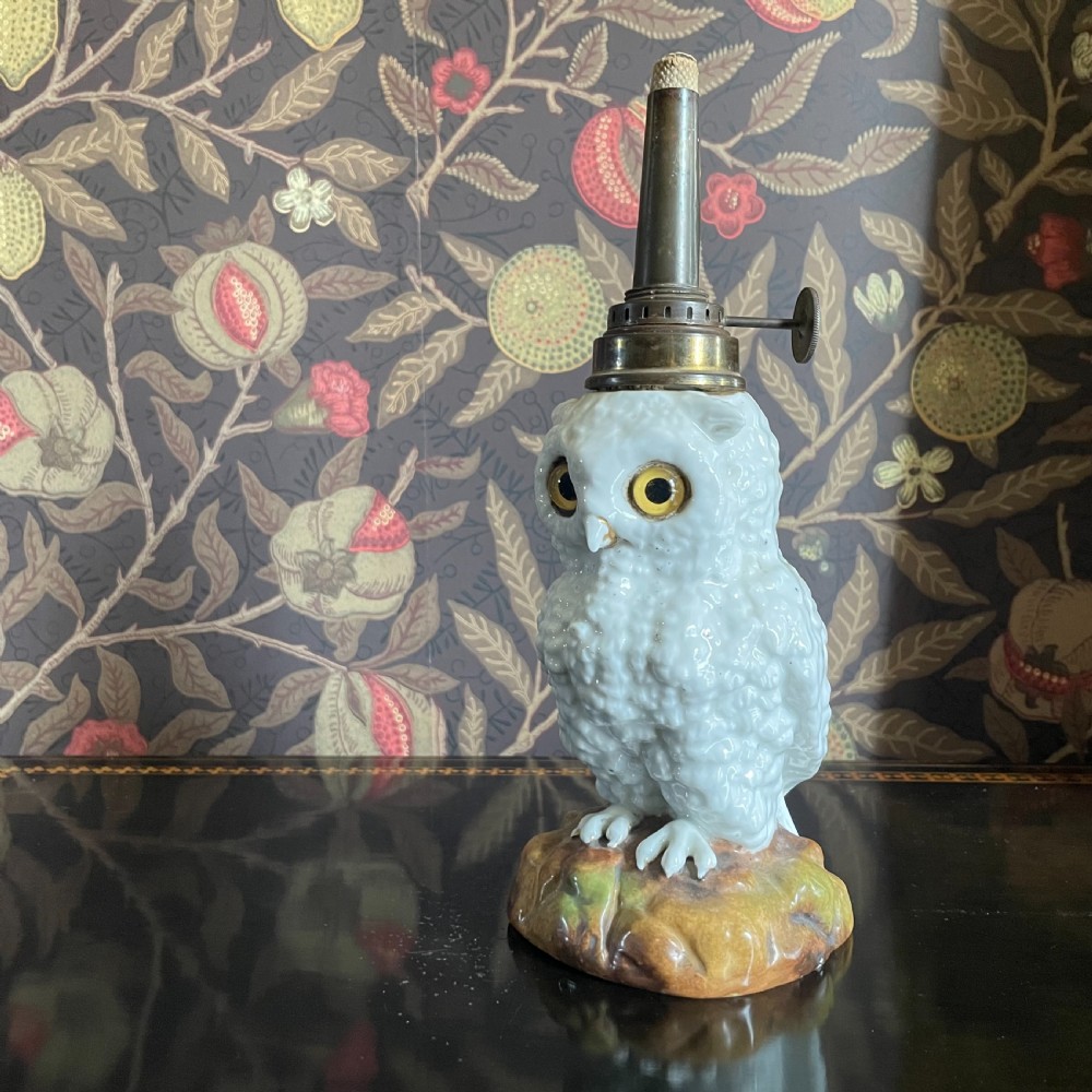 A Continental Porcelain Glass Eyed Owl Oil Lamp