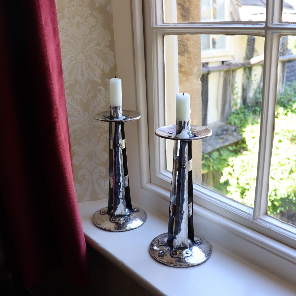 A PAIR OF ARTS AND CRAFTS SILVERED CANDLESTICKS View II