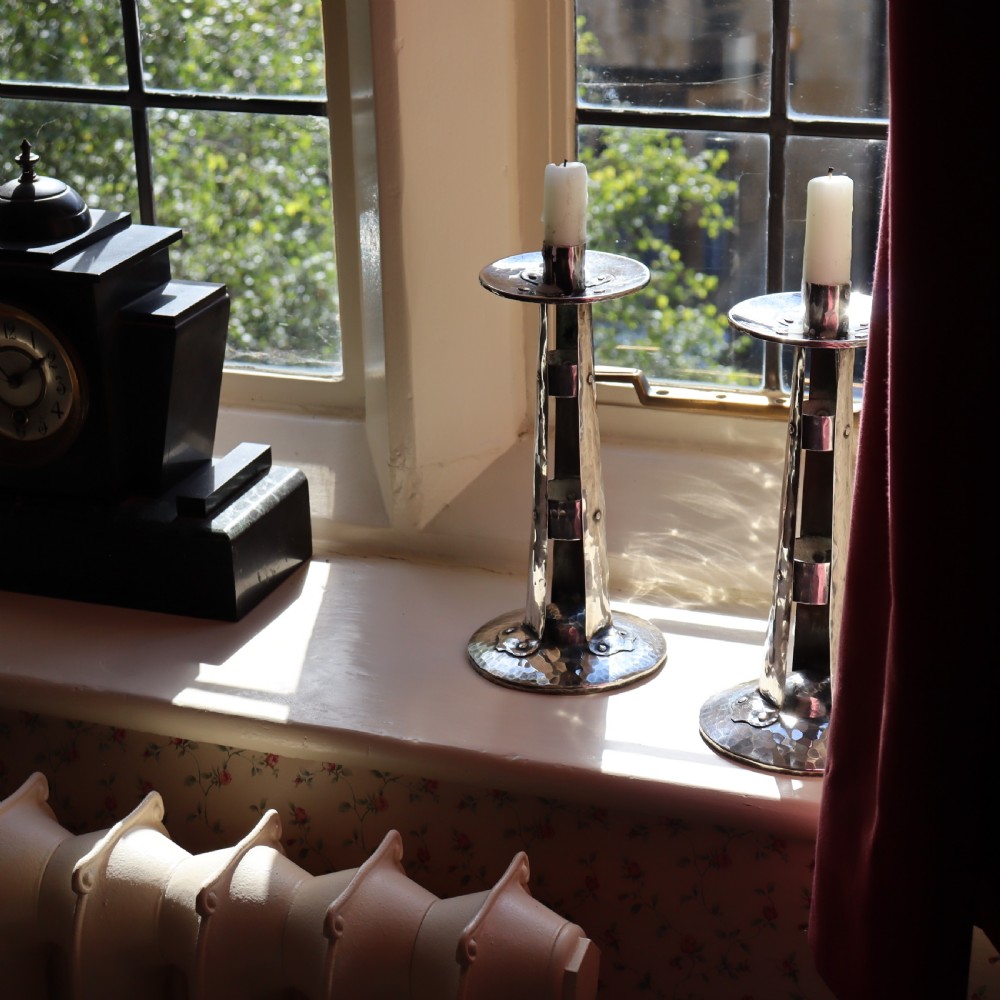 A PAIR OF ARTS AND CRAFTS SILVERED CANDLESTICKS View IV