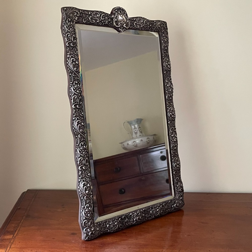 Henry Matthews, a Late Victorian Embossed Silver Framed Dressing Table Mirror 