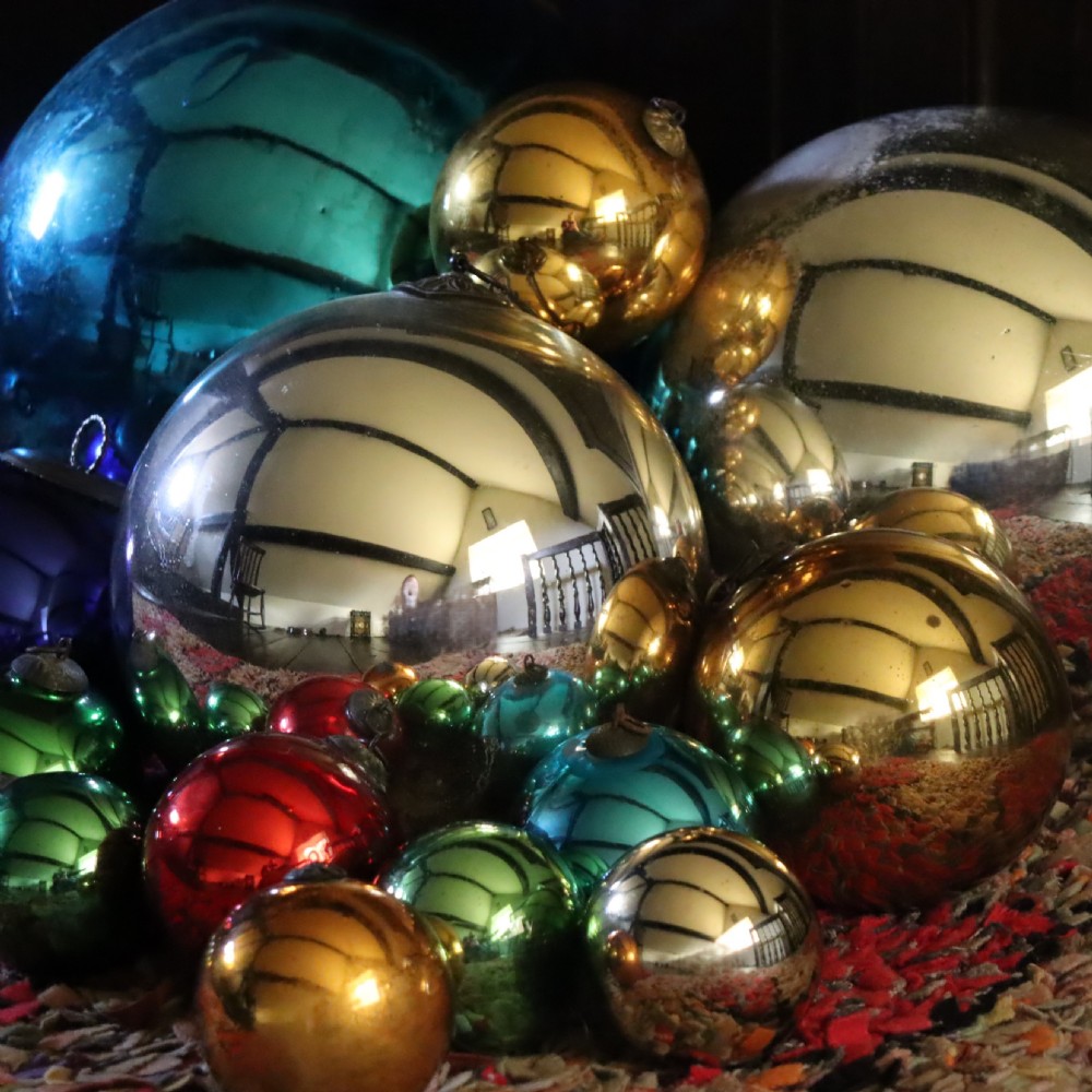 A collection of fifteen antique blown glass witches balls in varying sizes and reflective metallic colours including silver, gold, blue, green, and red. View II