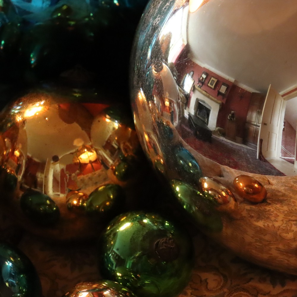 A collection of fifteen antique blown glass witches balls in varying sizes and reflective metallic colours including silver, gold, blue, green, and red. View III