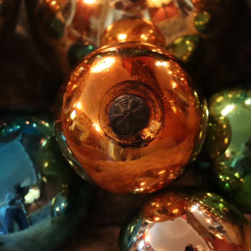 A collection of fifteen antique blown glass witches balls in varying sizes and reflective metallic colours including silver, gold, blue, green, and red. View V