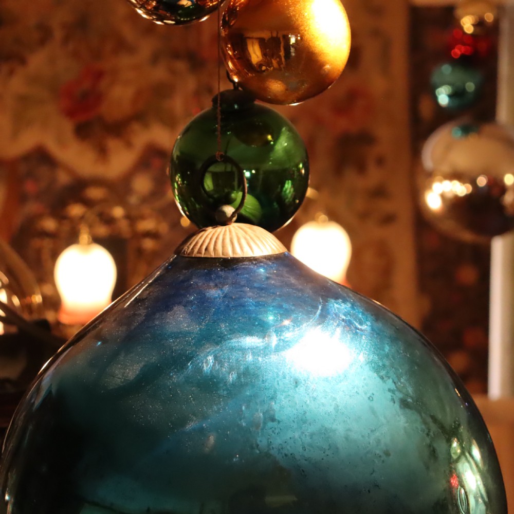 A collection of fifteen antique blown glass witches balls in varying sizes and reflective metallic colours including silver, gold, blue, green, and red. View IX