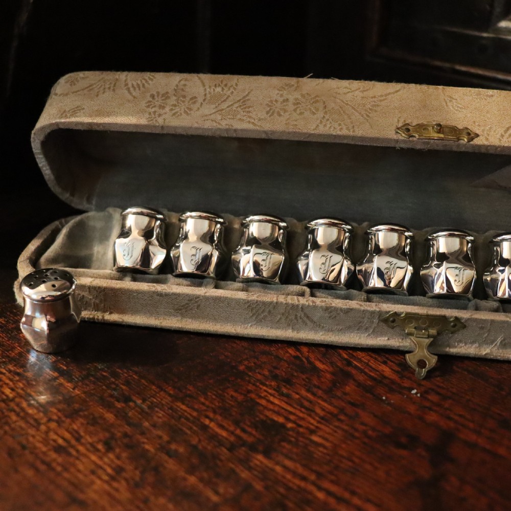 A full set of a dozen Victorian silver Pepperettes  View II