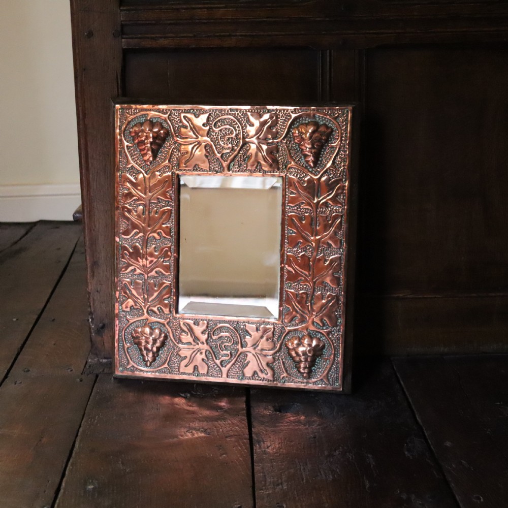 An Arts and Crafts copper repoussé wall mirror  View IV