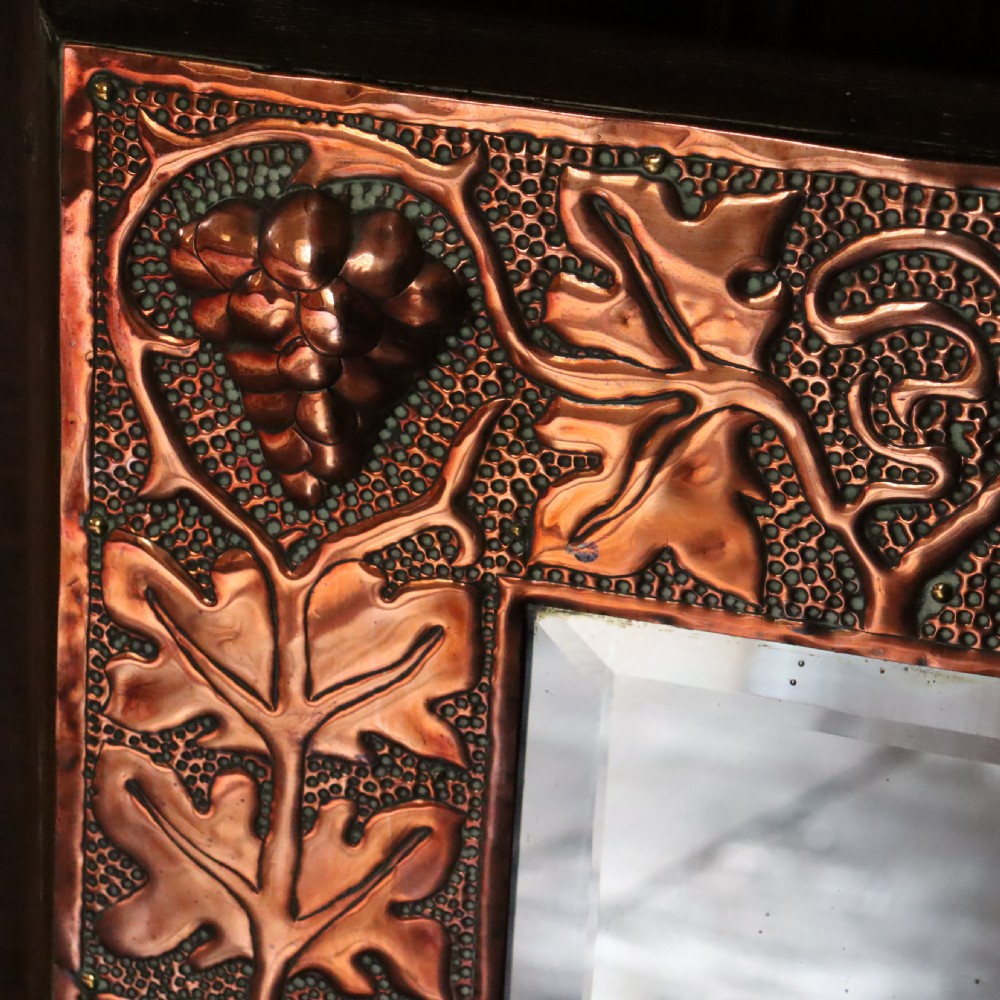 An Arts and Crafts copper repoussé wall mirror  View V