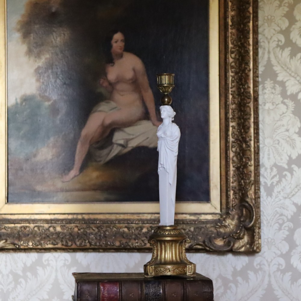 A 19th-century Neoclassical candlestick featuring a chased gilded bronze base and socket holding a sculpted white biscuit porcelain caryatid figure. View II