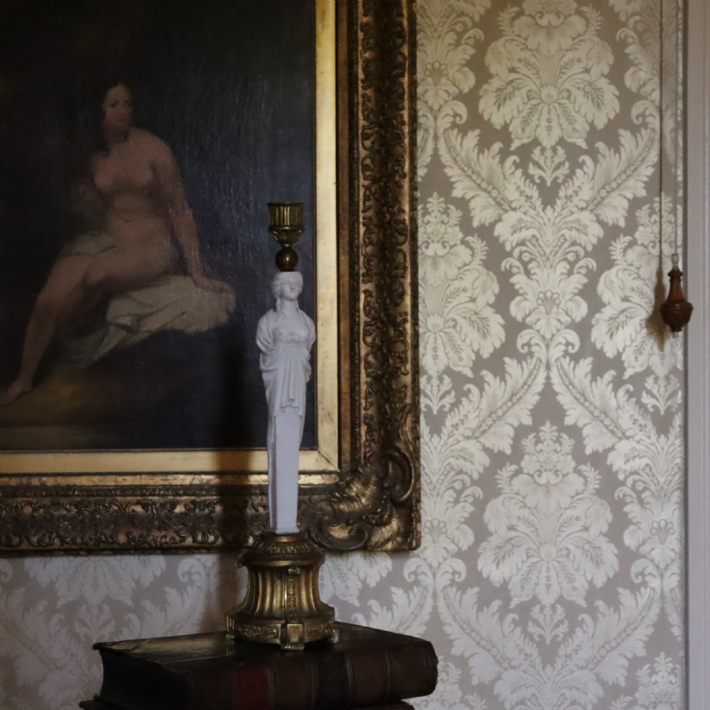 A 19th-century Neoclassical candlestick featuring a chased gilded bronze base and socket holding a sculpted white biscuit porcelain caryatid figure. View III