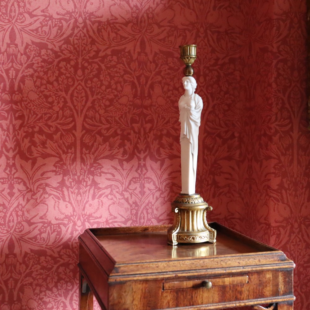 A 19th-century Neoclassical candlestick featuring a chased gilded bronze base and socket holding a sculpted white biscuit porcelain caryatid figure. View VI