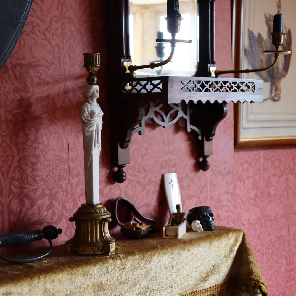 A 19th-century Neoclassical candlestick featuring a chased gilded bronze base and socket holding a sculpted white biscuit porcelain caryatid figure. View VII
