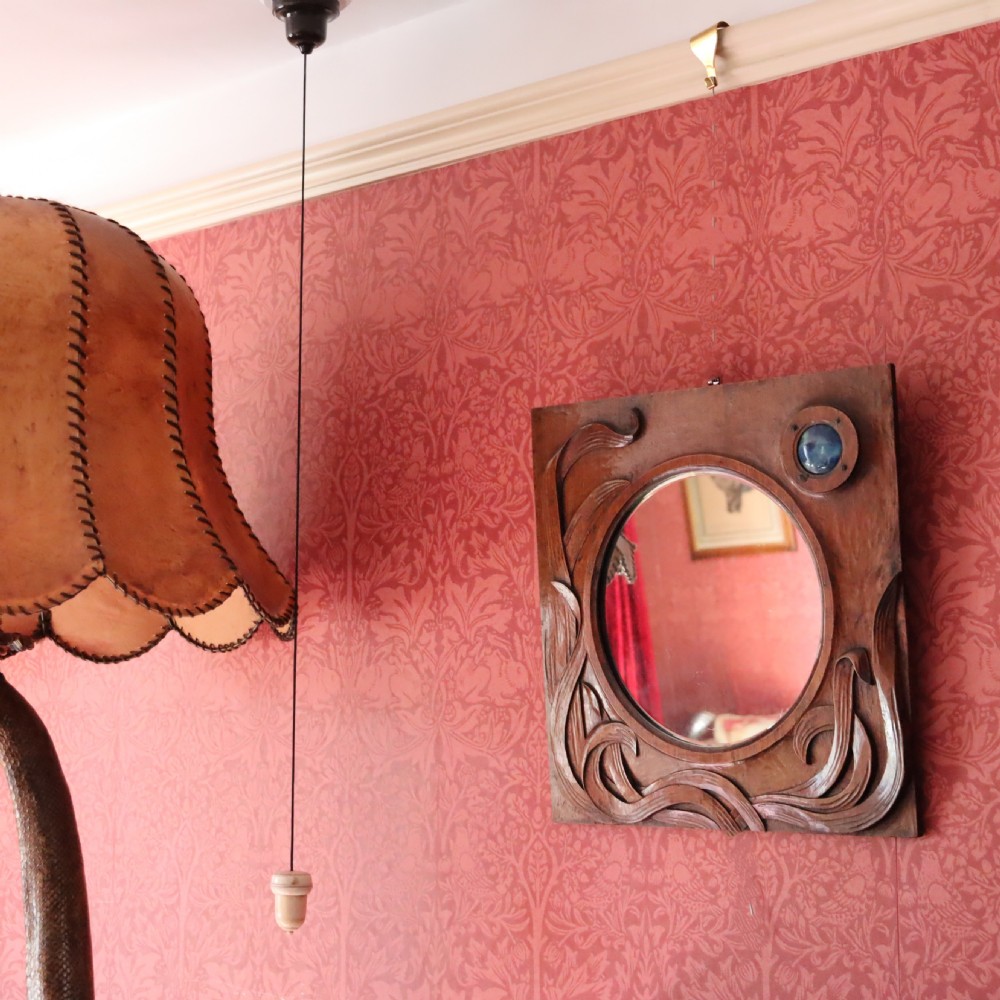 An Arts and Crafts carved wood wall mirror  View II