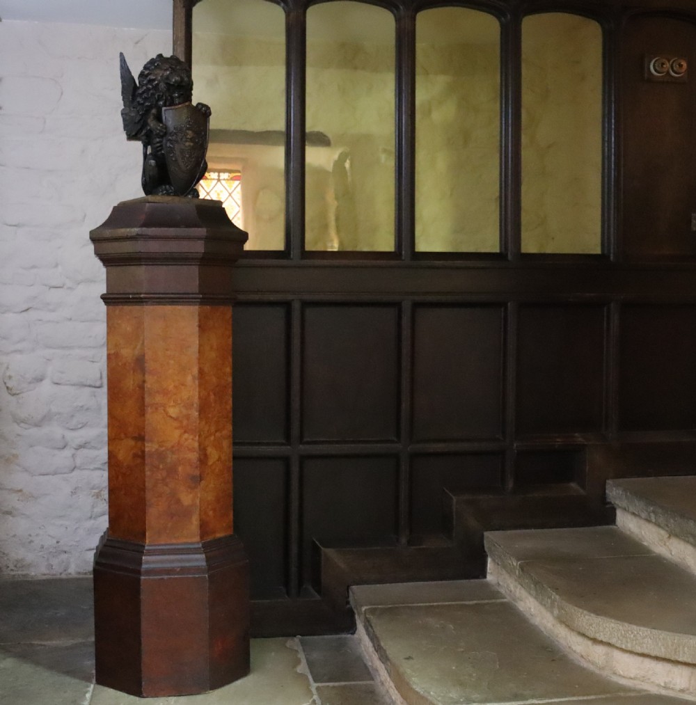 A tall octagonal Victorian column featuring a hand-painted faux marble shaft in warm ochre tones supported by a dark brown octagonal base and capital. View II