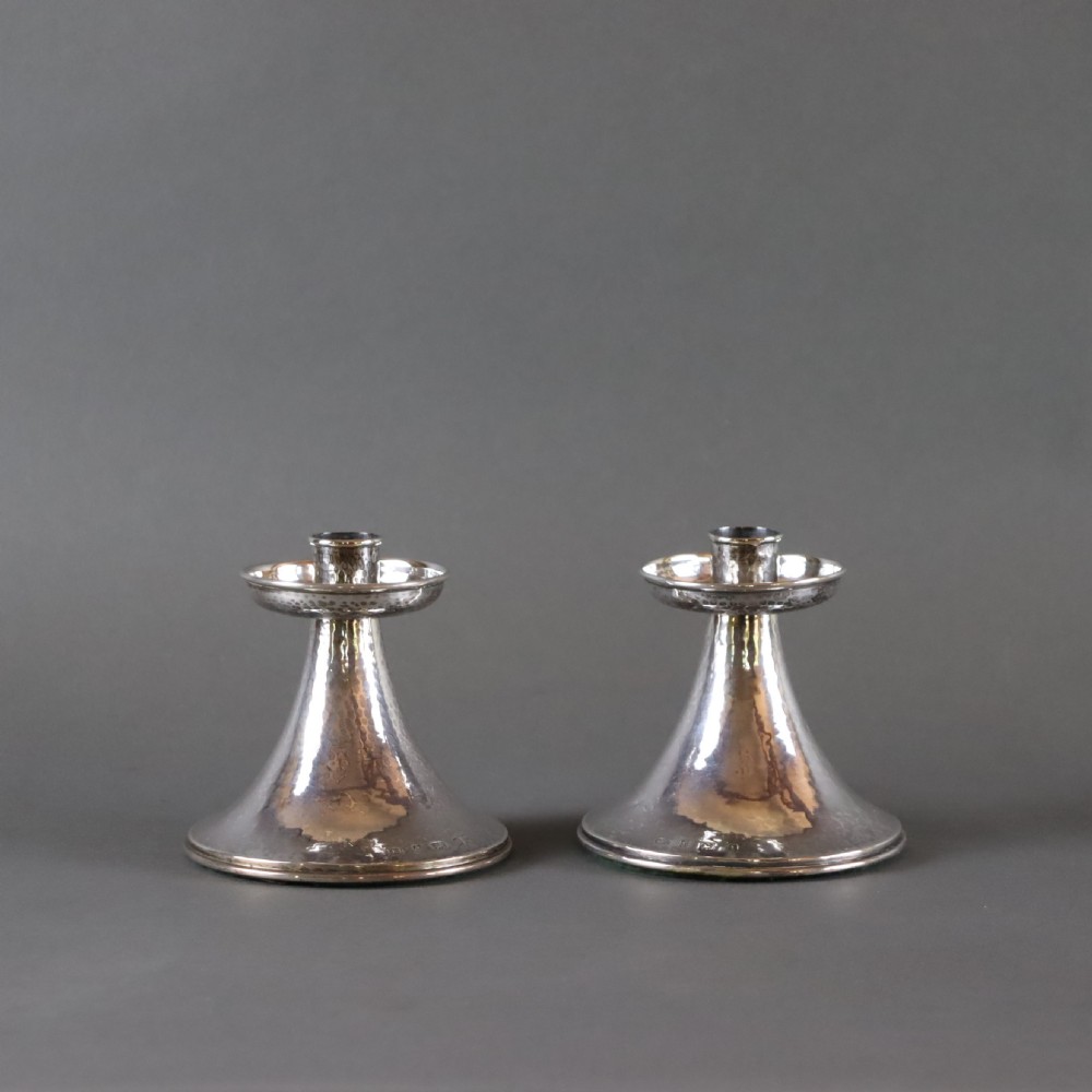 A fine pair of A.E.JONES Arts & Crafts silver candlesticks