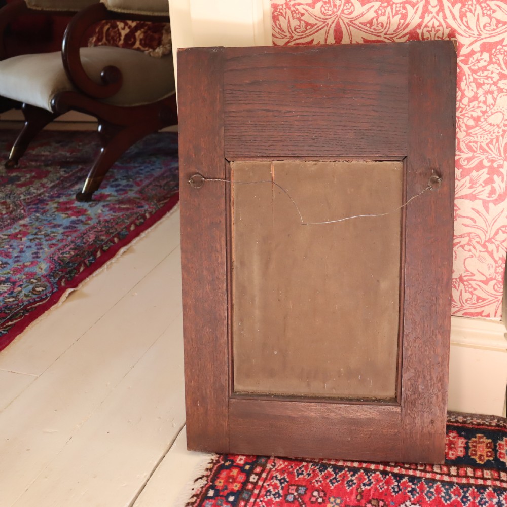 An Arts and Crafts repoussé and oak framed mirror. View VII