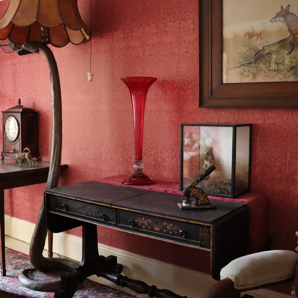 A tall Victorian trumpet-shaped vase made of deep red cranberry glass with a clear glass knop and circular foot. View IV