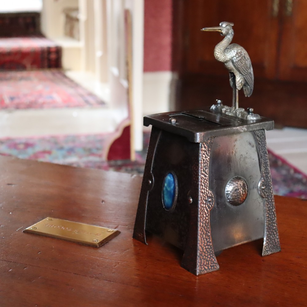 An Arts and Crafts Ruskin set mechanical ‘Stork’ cigarette dispenser