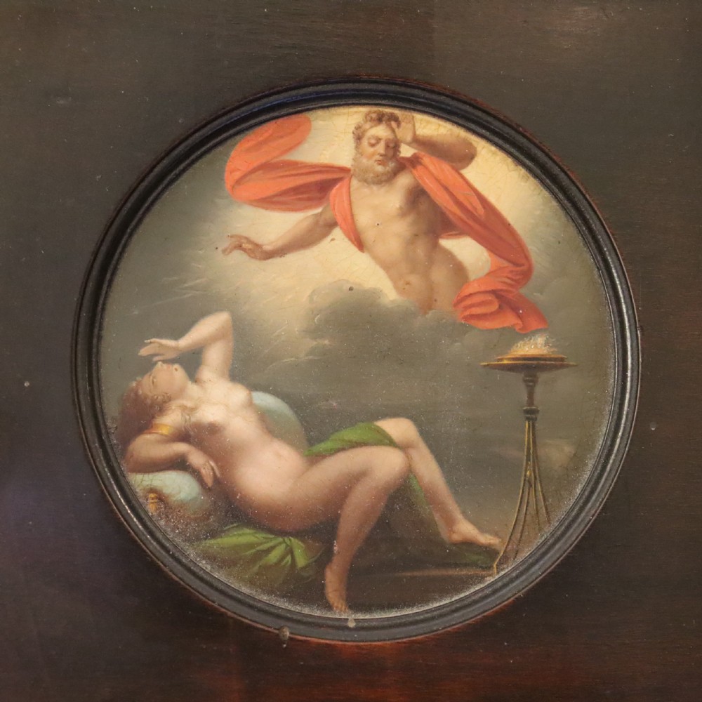 A small circular early 19th-century mythological oil painting depicting a reclining nude nymph and floating male god, encased in a square, highly ornate giltwood frame. View III