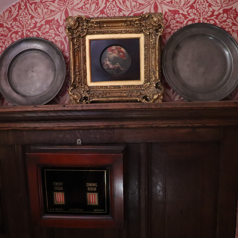 A small circular early 19th-century mythological oil painting depicting a reclining nude nymph and floating male god, encased in a square, highly ornate giltwood frame. View VI