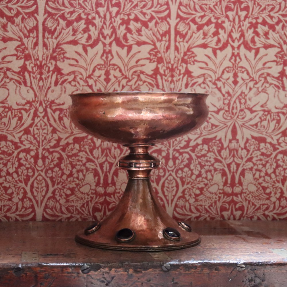 A hand-hammered copper pedestal bowl featuring a flared base set with circular blue enamel cabochons. View III
