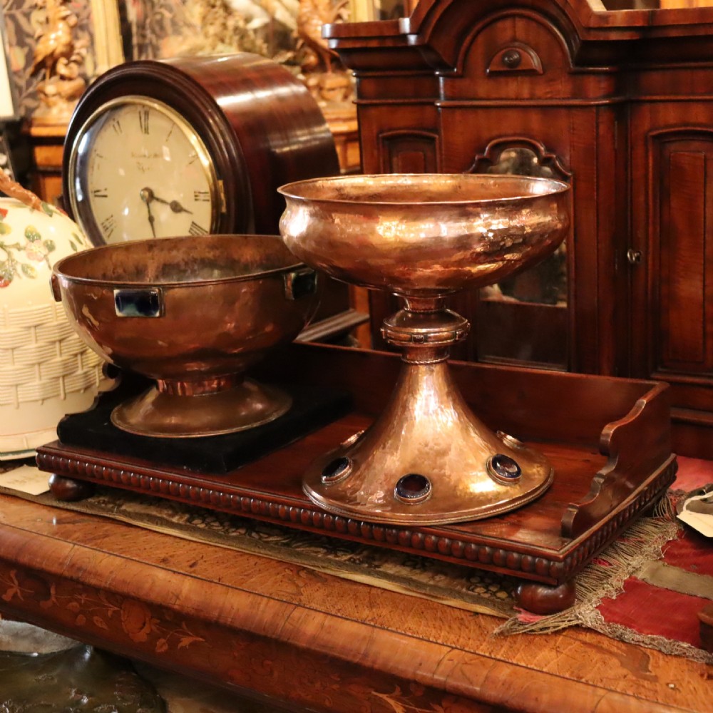 A hand-hammered copper pedestal bowl featuring a flared base set with circular blue enamel cabochons. View VIII