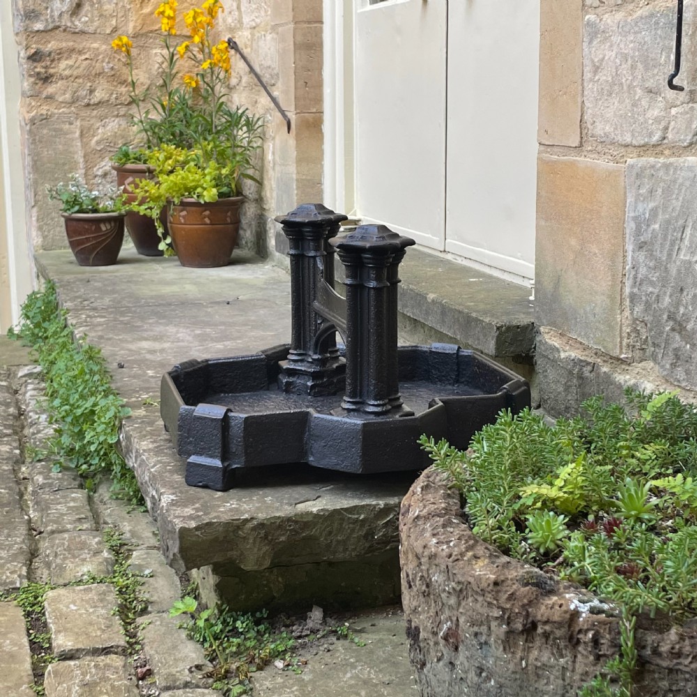 A heavy Victorian cast iron boot scraper featuring Gothic revival pointed arches, twin clustered columns, and an integrated tray base. View II