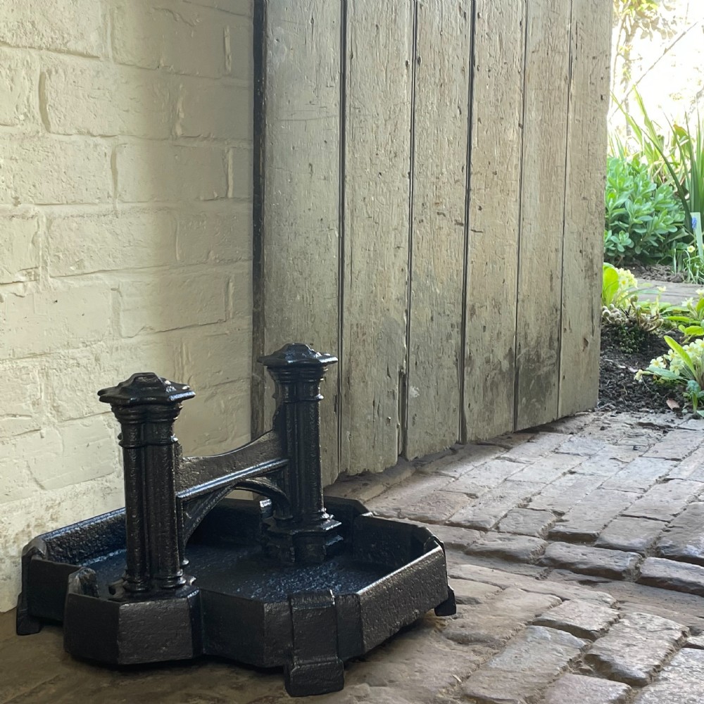 A heavy Victorian cast iron boot scraper featuring Gothic revival pointed arches, twin clustered columns, and an integrated tray base. View III