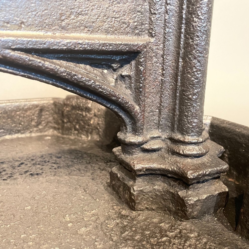 A heavy Victorian cast iron boot scraper featuring Gothic revival pointed arches, twin clustered columns, and an integrated tray base. View IV