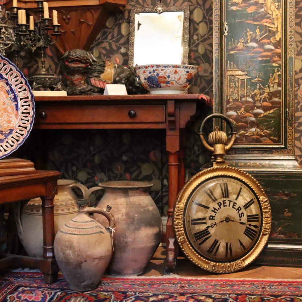 A late 19th-century oversized pocket watch trade sign with a gilded frame, Roman numerals on the dial, and embossed text reading Watches, Jewellery, Clocks. View III