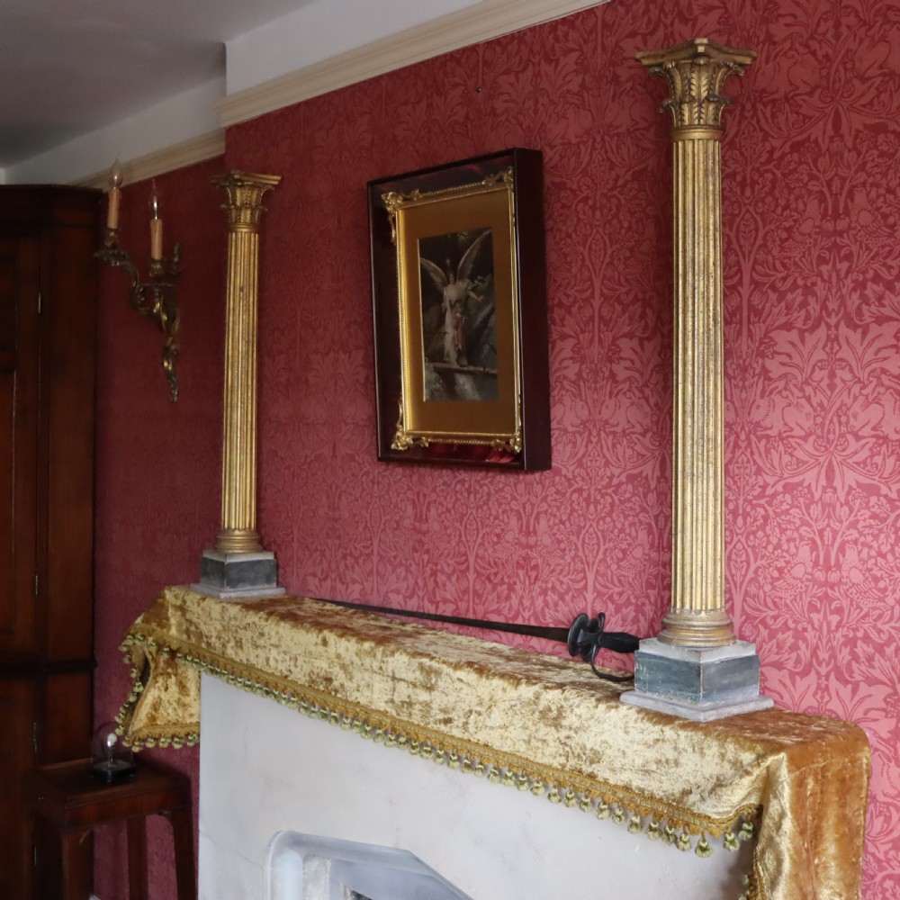 A pair of decorative 19th century carved and gilt wood fluted Corinthian columns View V