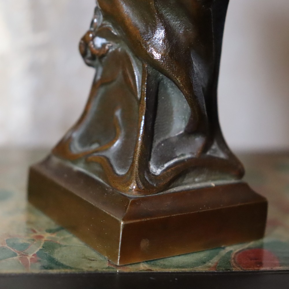 An Art Nouveau patinated bronze bust depicting a young woman adorned with ears of wheat and flowing drapery, set on a gilt base. View VI