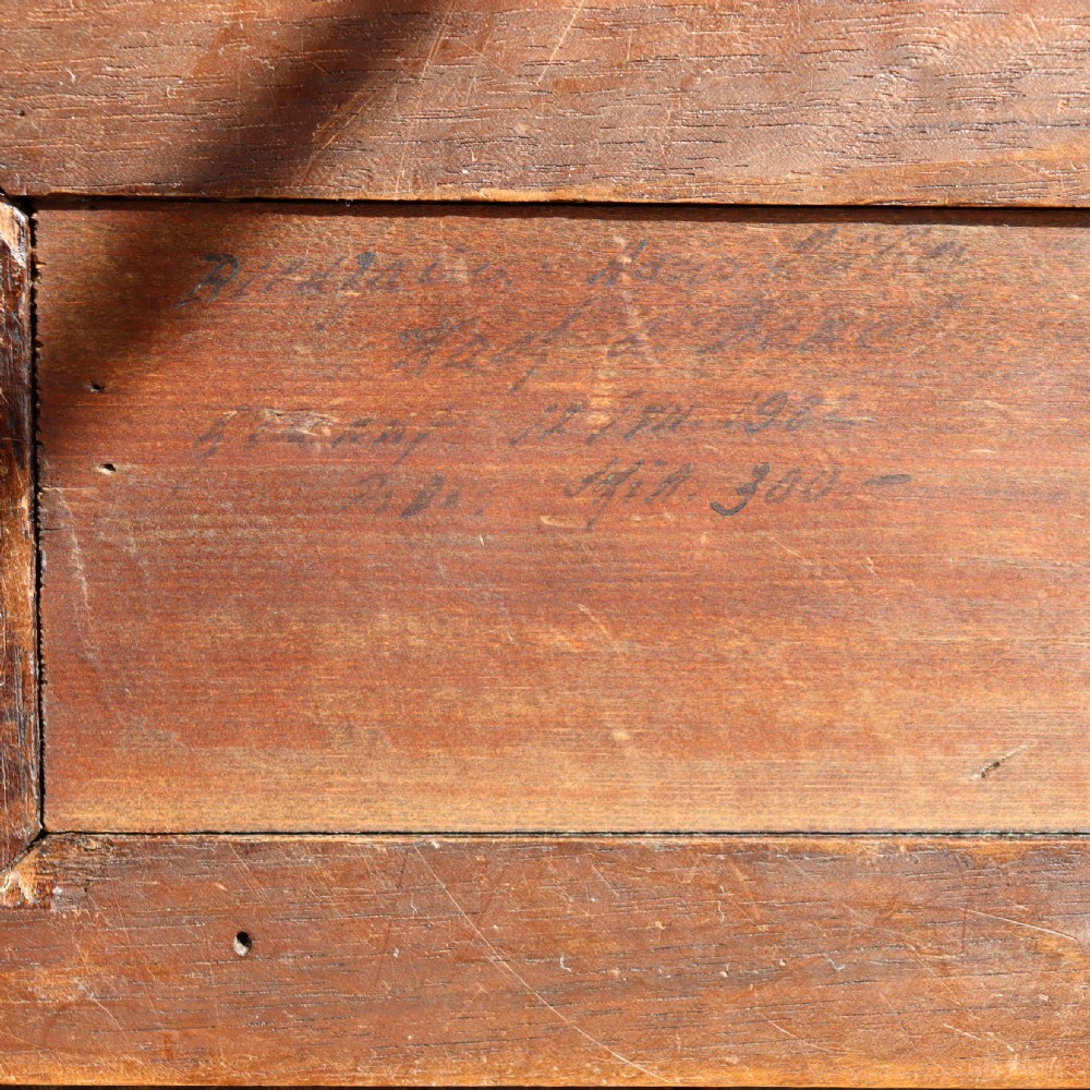A carved warm brown limewood sculpture depicting a seated female nude figure on a molded rectangular plinth. View VI