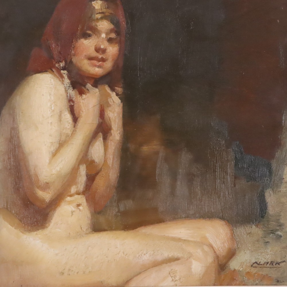 A framed antique oil painting depicting a seated female nude with a red head covering, presented in a light cream moulded wooden frame. View V