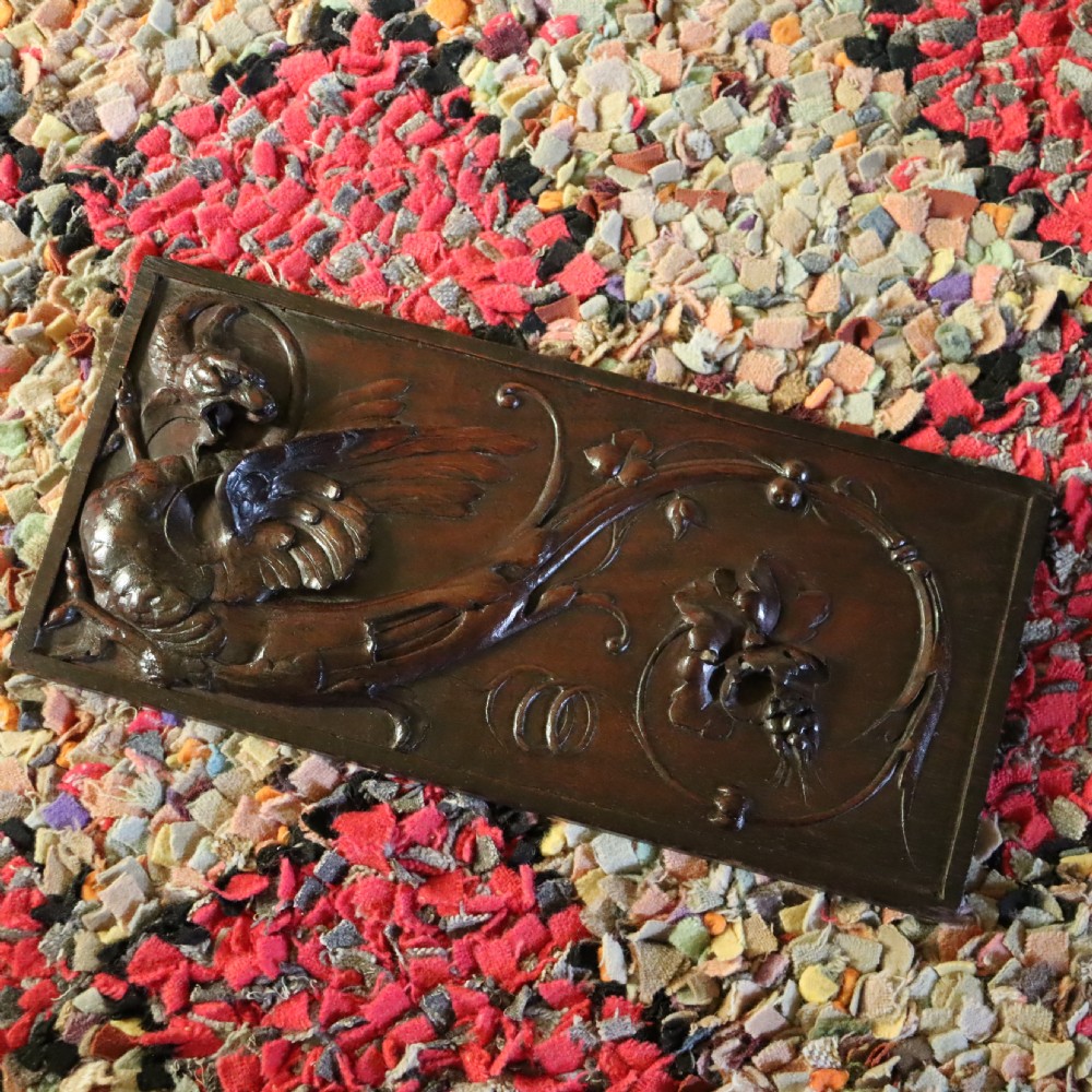 A 19th century carved walnut wall panel depicting a Wyvern or dragon View III