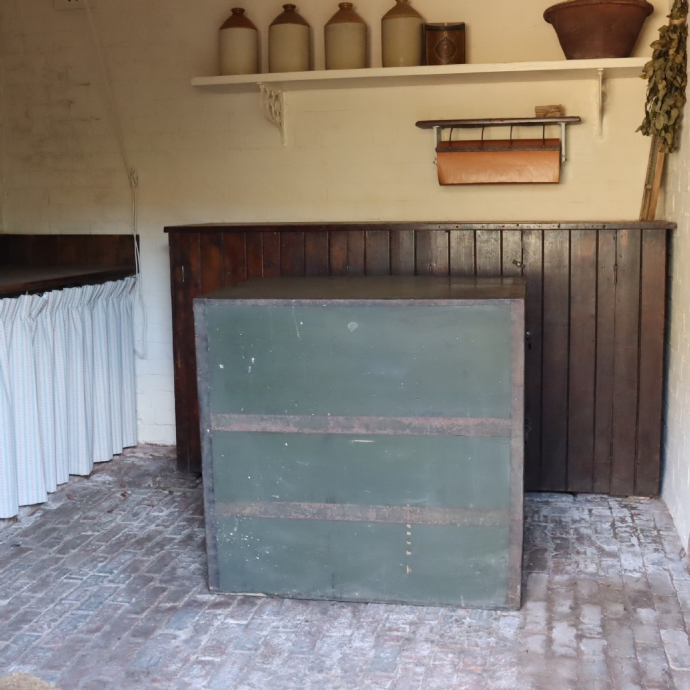 A large dark green metal-bound military campaign travelling case with stencilled lettering on the front panels and iron drop handles on the side. View IV