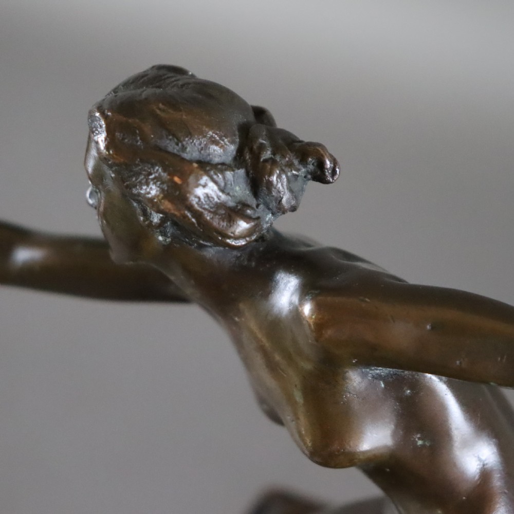 An Art Deco dark bronze sculpture of a kneeling nude woman reaching forward, mounted on a rustic square timber base. View II