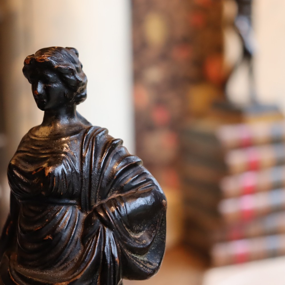 A dark ebonised carved wood figure of the classical goddess Fortuna set atop a gilded fluted column pedestal and square base. View III