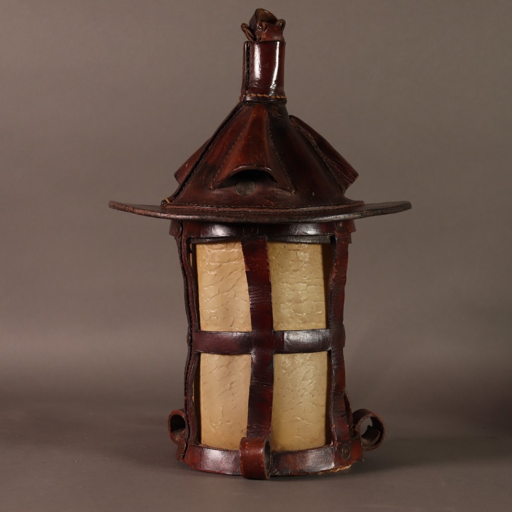 An Arts and Crafts ceiling lantern made of dark chestnut brown hand-stitched leather straps surrounding translucent vellum panels, suspended by a metal chain. View IV