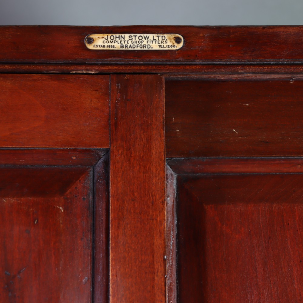 A Victorian mahogany and glass corner display cabinet featuring three glass shelves and mirrored back doors. View III