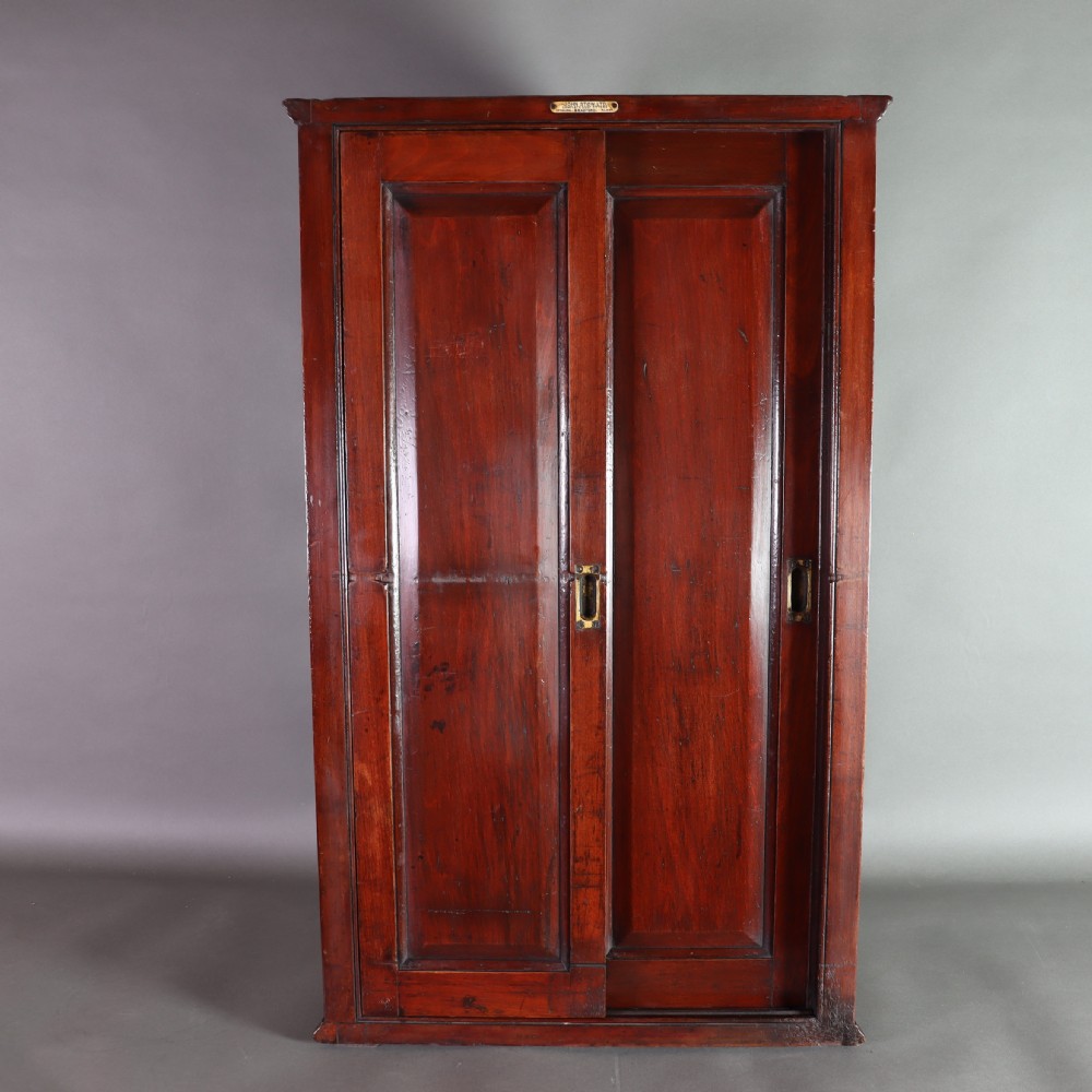 A Victorian mahogany and glass corner display cabinet featuring three glass shelves and mirrored back doors. View V