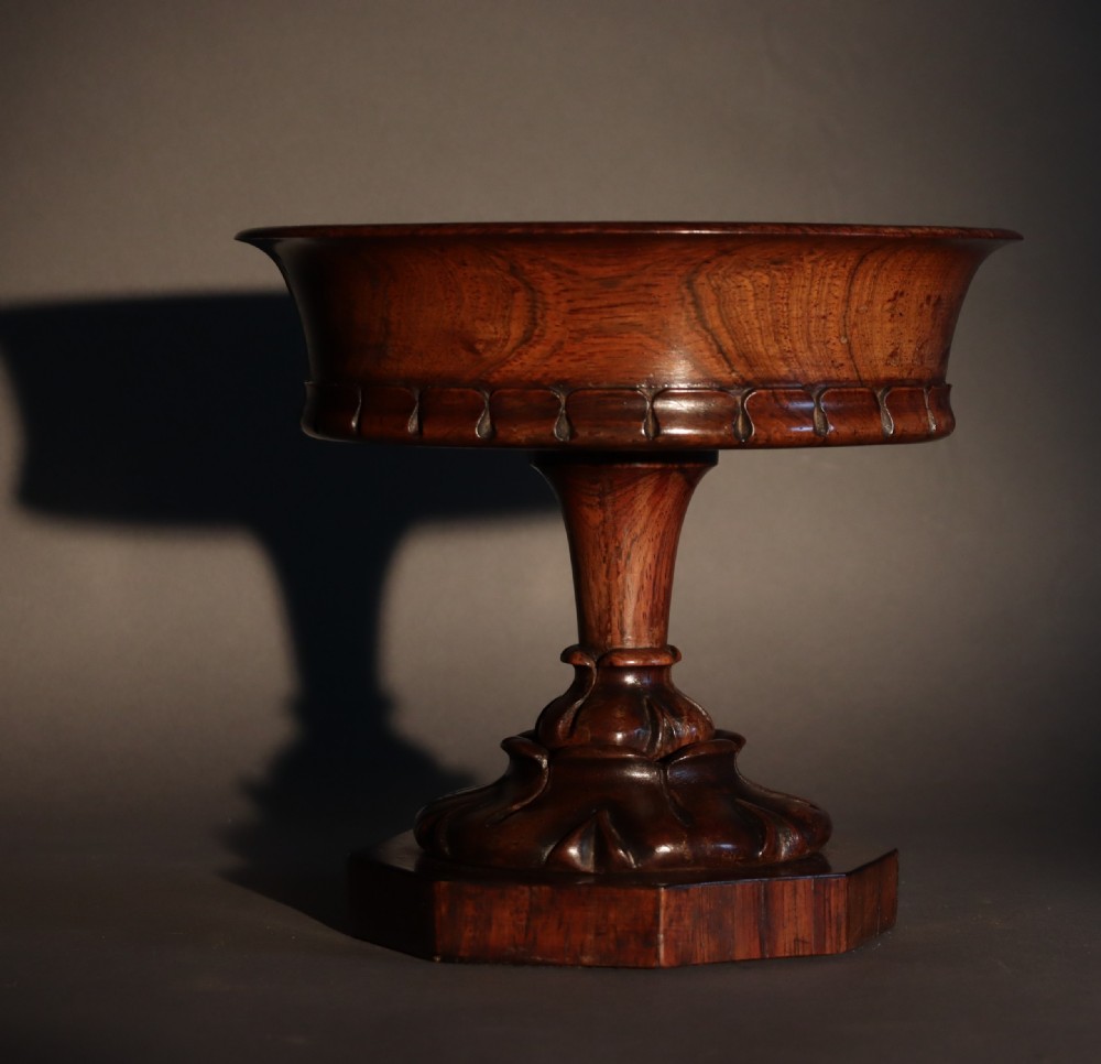 A dark rosewood tazza urn featuring a circular flared rim with an integrated brass liner, supported by a turned pedestal on an octagonal wooden base. View III