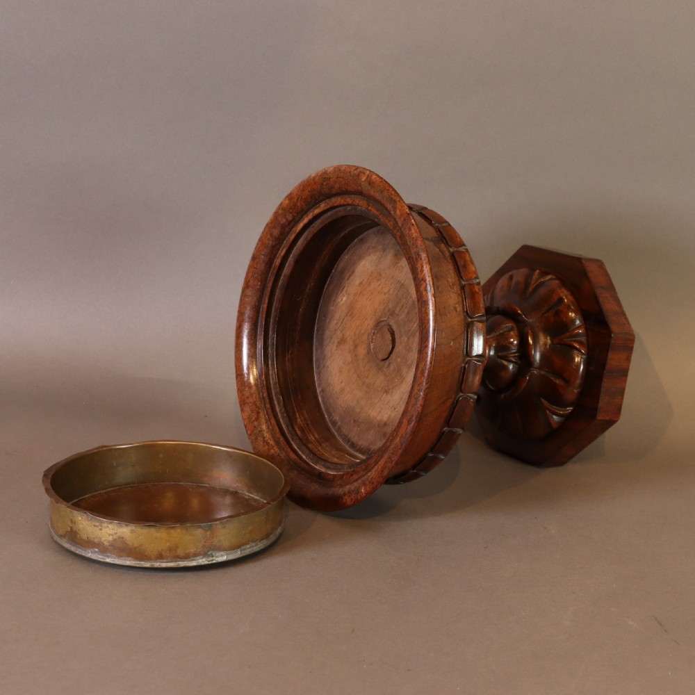 A dark rosewood tazza urn featuring a circular flared rim with an integrated brass liner, supported by a turned pedestal on an octagonal wooden base. View VIII