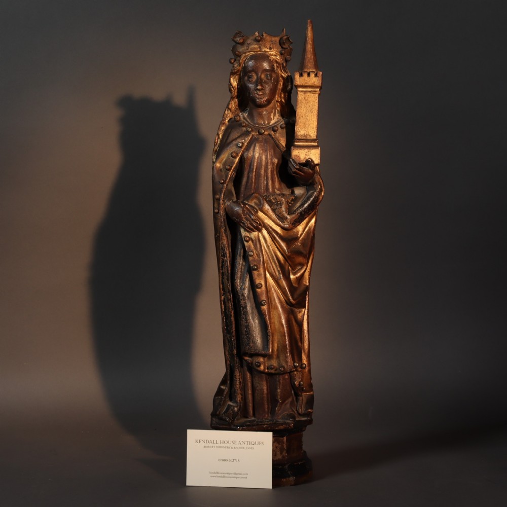 A 17th-century German carved polychrome and giltwood sculpture depicting Saint Barbara holding a tower, standing upon an inscribed plinth. View VIII
