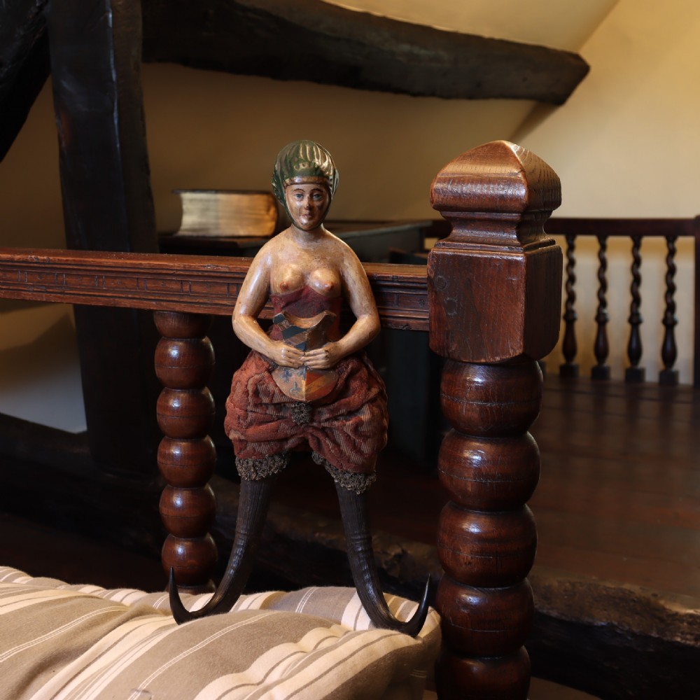 A 19th-century carved wood and horn wall hook featuring a polychrome figure of a female torso above curved dark horns forming the hooks. View III