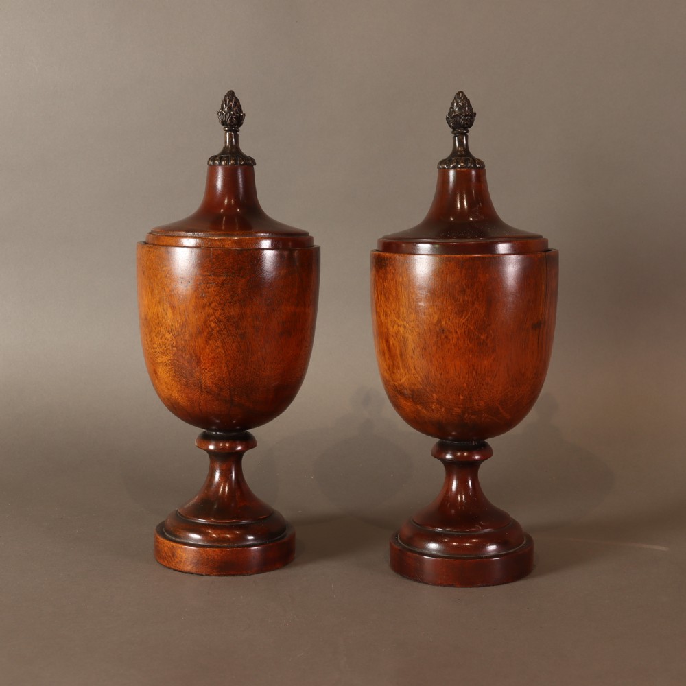 Treen – Pair of Neo Classical mid 19th Century mahogany lidded urns with brass pineapple inspired finials. 