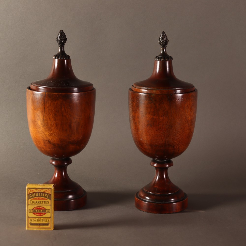Treen – Pair of Neo Classical mid 19th Century mahogany lidded urns with brass pineapple inspired finials.  View VII