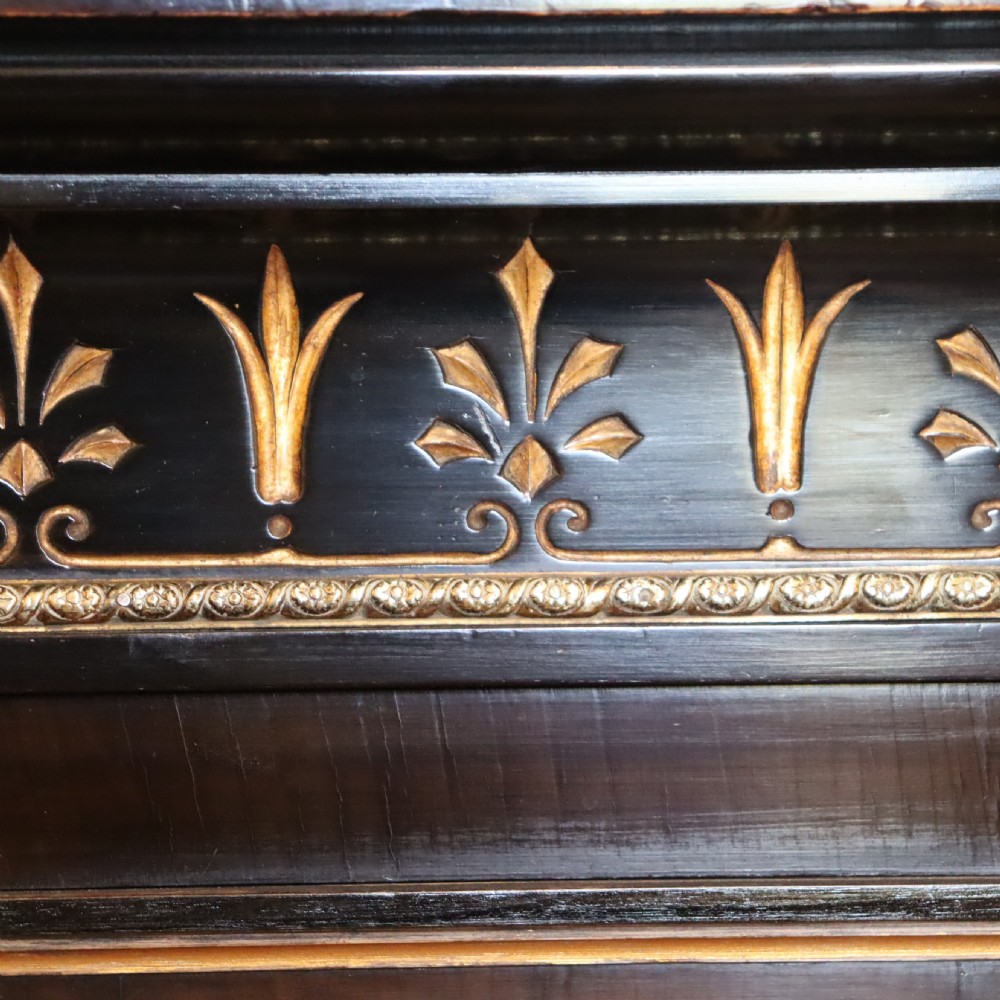 An ebonised Victorian Aesthetic Movement display pedestal featuring inset burr walnut panels, gilt incised frieze detailing, and a moulded square top. View VI