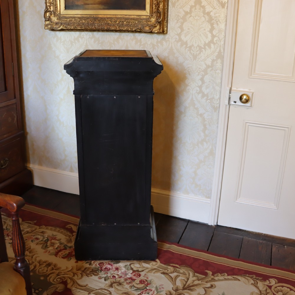 An ebonised Victorian Aesthetic Movement display pedestal featuring inset burr walnut panels, gilt incised frieze detailing, and a moulded square top. View VIII