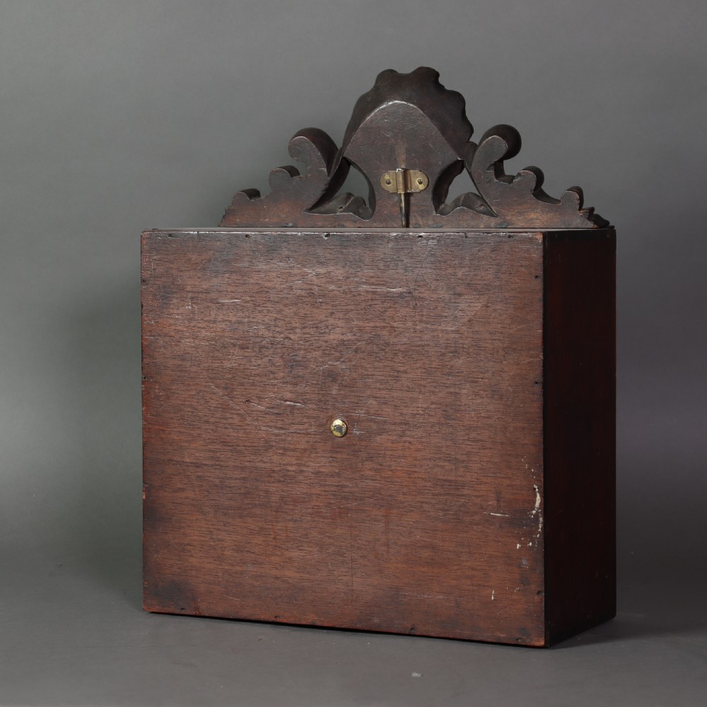 A Victorian miniature fireplace model with brass and iron hearth details, enclosed in a dark wood cabinet with a shell carved pediment. View V